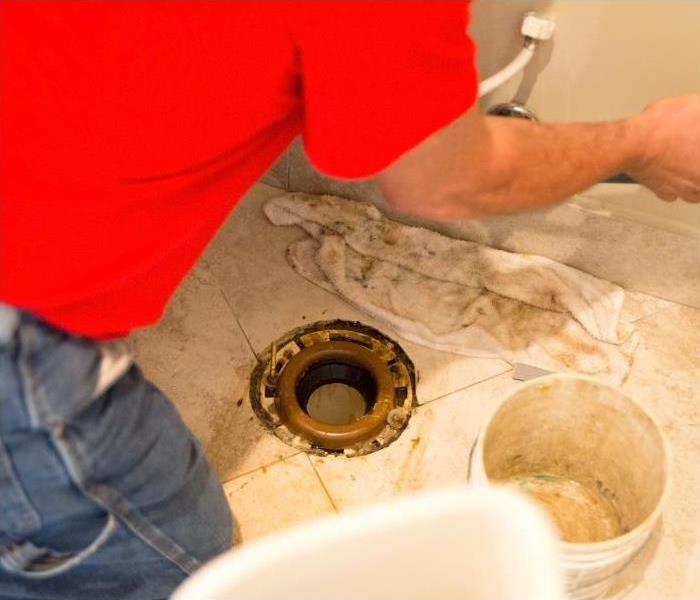 Professional repairing a leak in the toilet